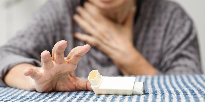 a woman reaching for her inhaler for breathing problems