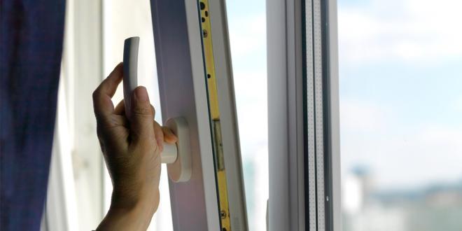 woman opening window for fresh air