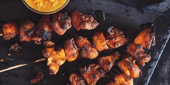 Chicken Satay skewers with a bowl of peanut dipping sauce on the side