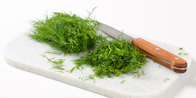 Sprigs of fresh dill on a cutting board