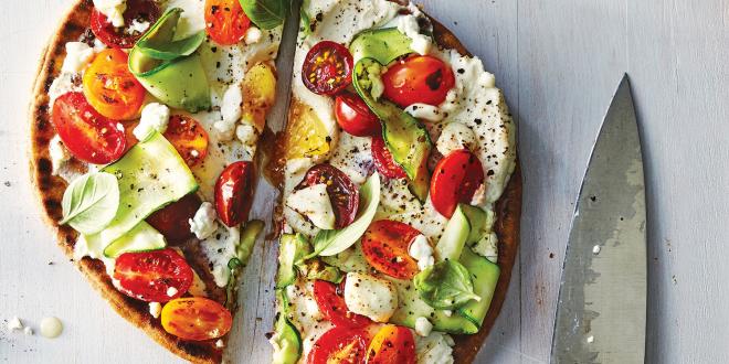 Ricotta and Zucchini Flatbread on a white washed wooden table.