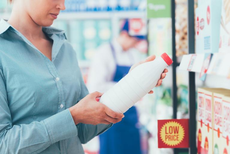 a woman reading labels in the grocery store